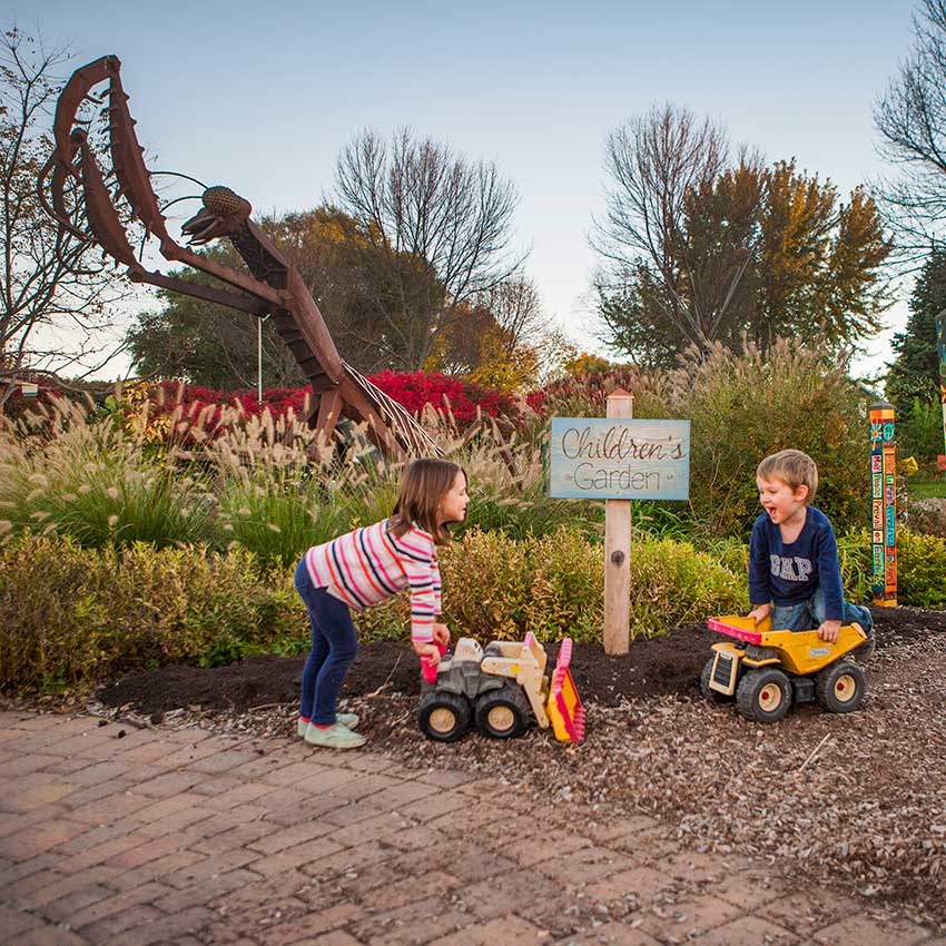 image of two children playing in a children's garden